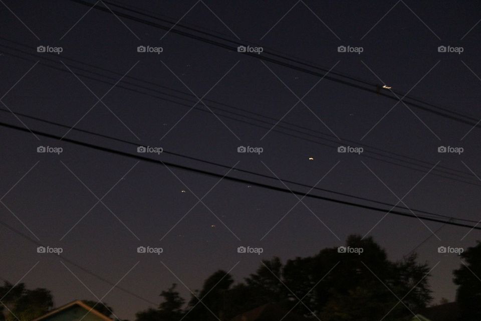 stars in noght sky through telephone wires