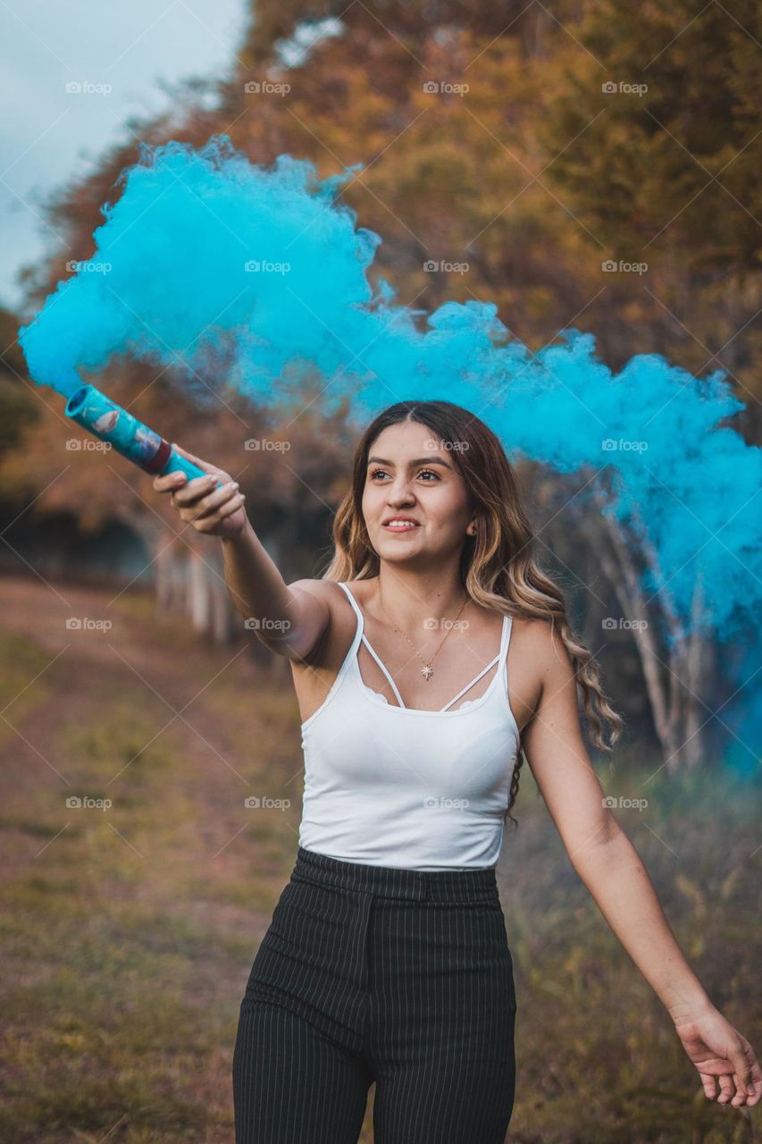 Photograph of girl playing with smoke bombs