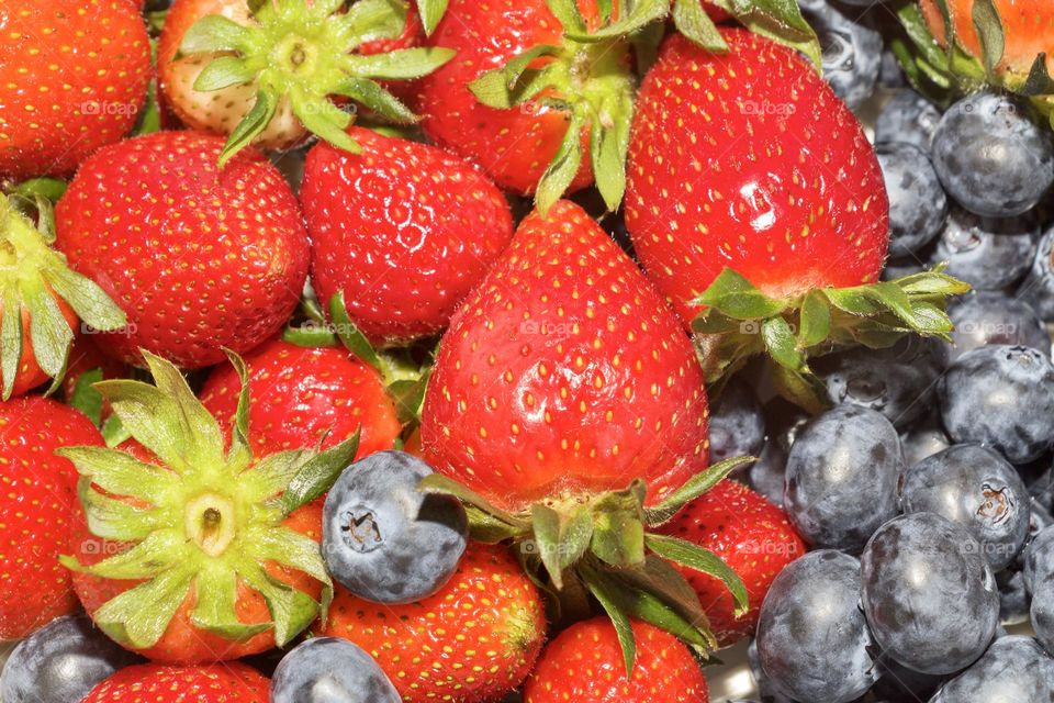 Close up of delicious strawberries and blueberries 
