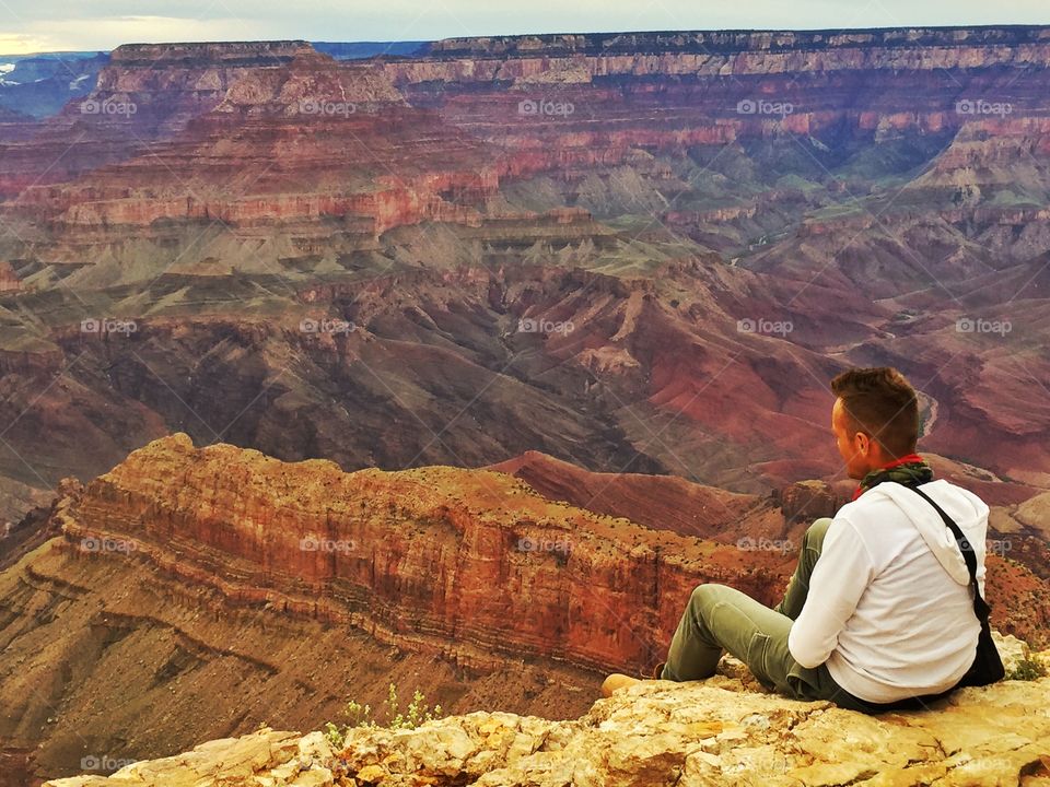 A man takes a rest and looks the magic grand canyon
