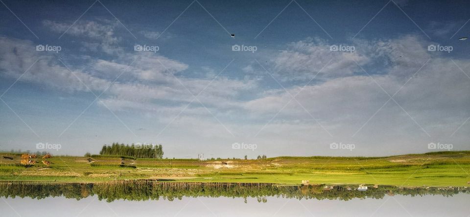 sky on water. the photo was captured in Bangladesh, when the beautiful sky reflected in water, the photo  is rotated 180'
loo