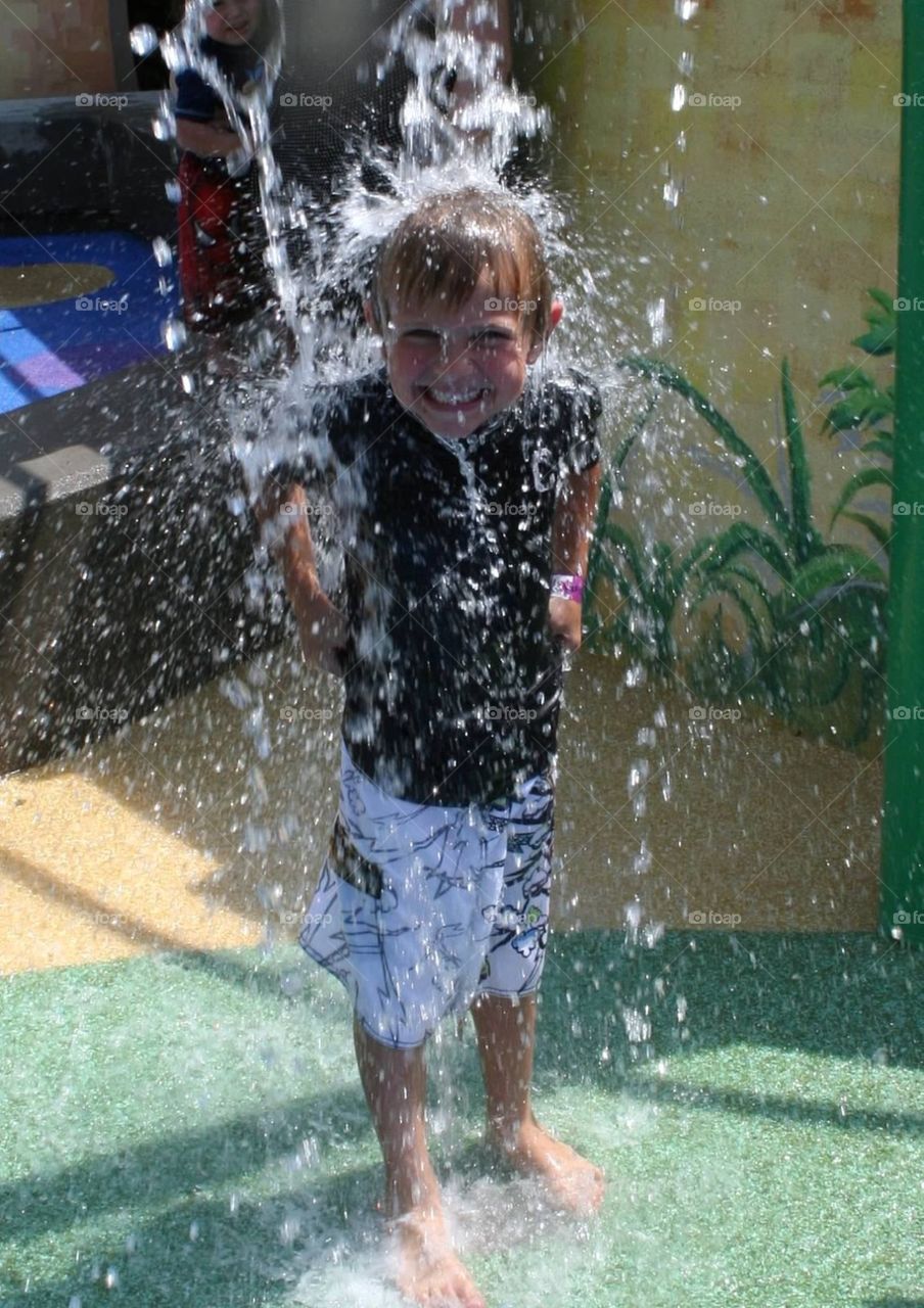 Splash zone!. My son playing in a splash pad...so awesome being a kid!
