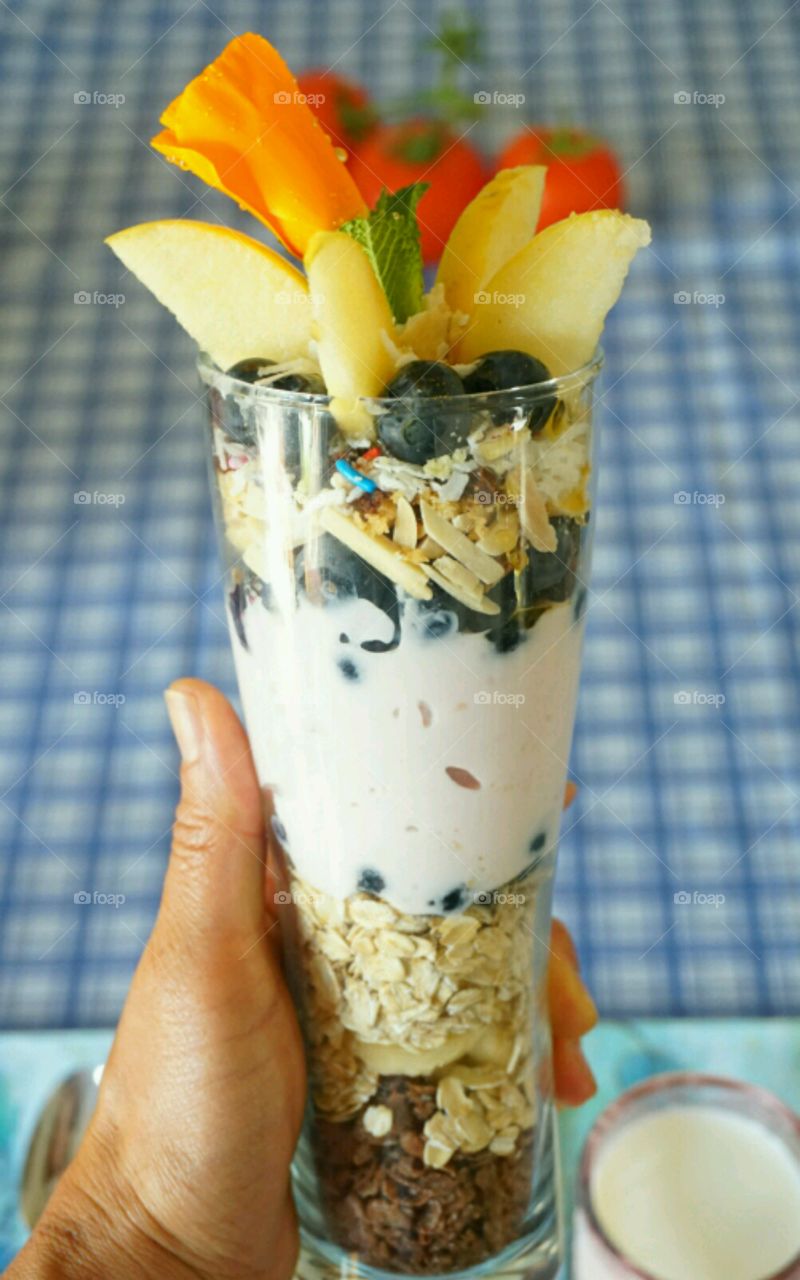 Fresh fruit smoothie - blueberry banana coconut strawberries and nuts