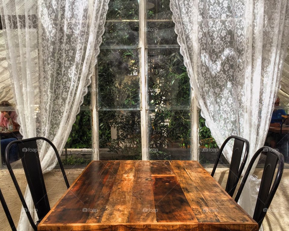 A table and chairs by the window