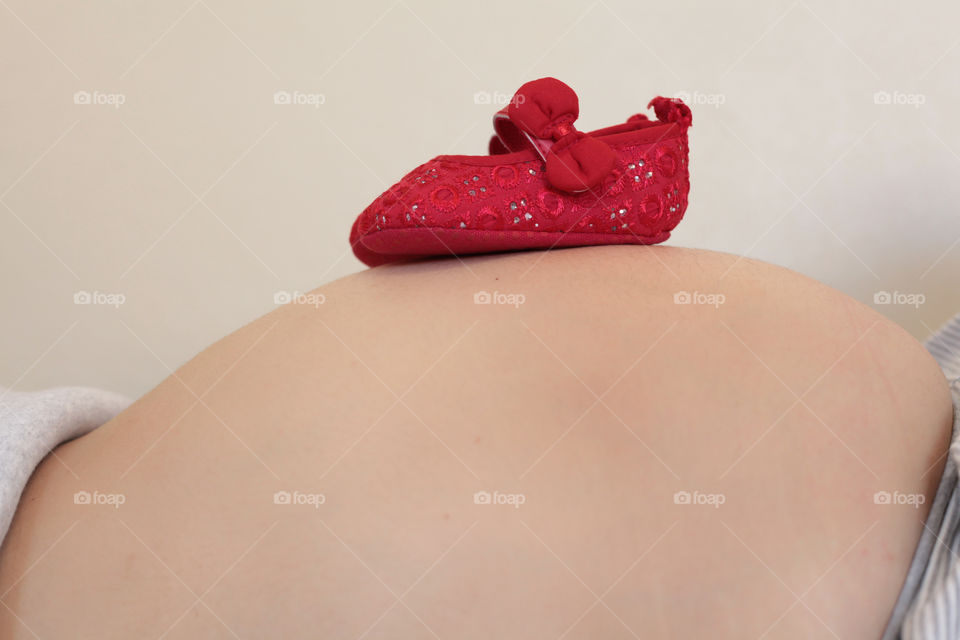pregnant woman expecting baby girl red baby girl shoes maternity