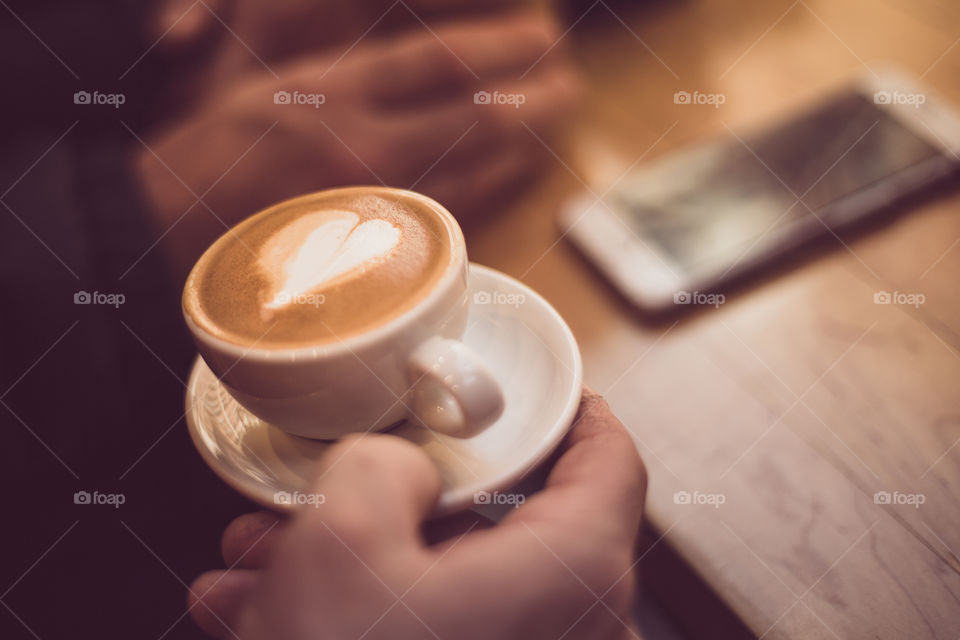 A human holding coffee