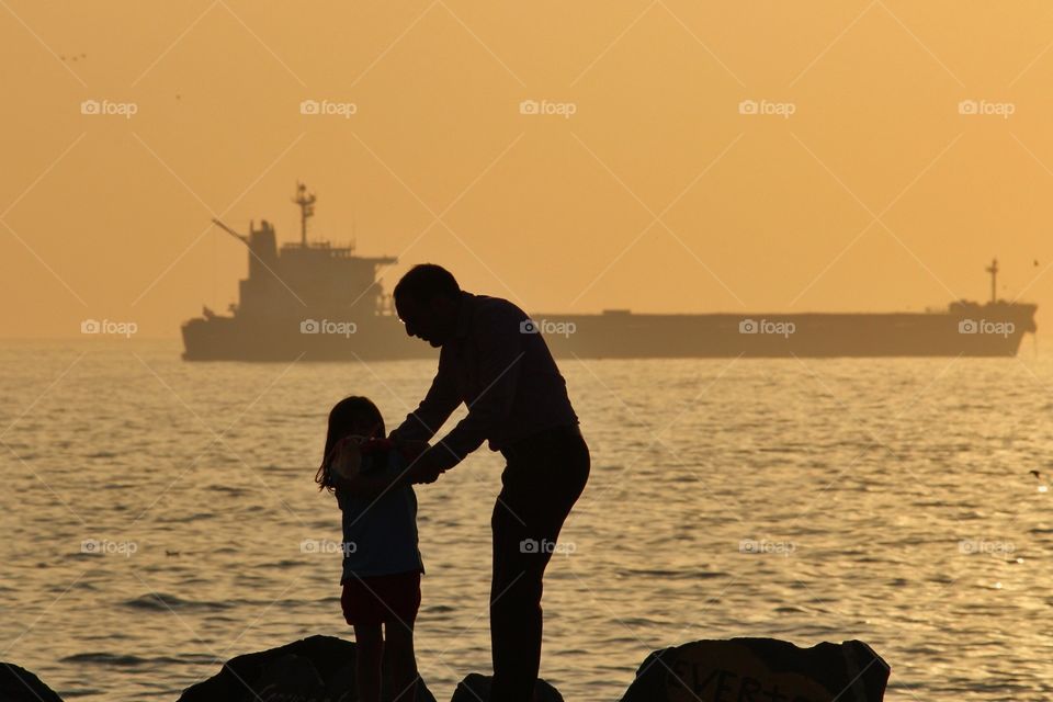 Father and daughter enjoy sunset