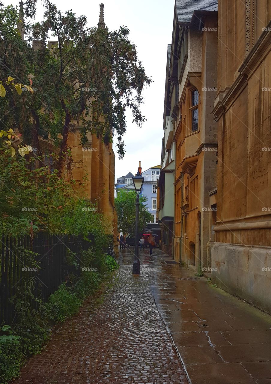 an old street lamp in a small alley