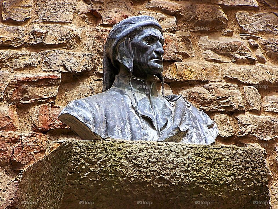 A bust of Dante Alighieri that is displayed just outside the entrance to his birthplace and home in Florence, Italy.