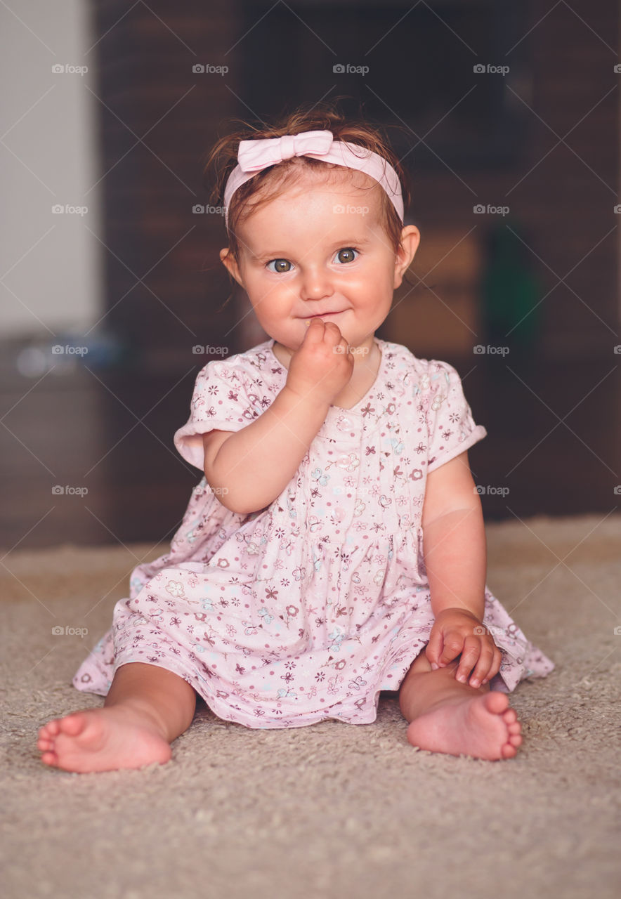 Portrait of cute girl sitting on rug