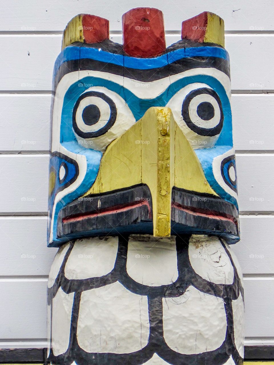 The colorful head of a totem pole in Alaska
 