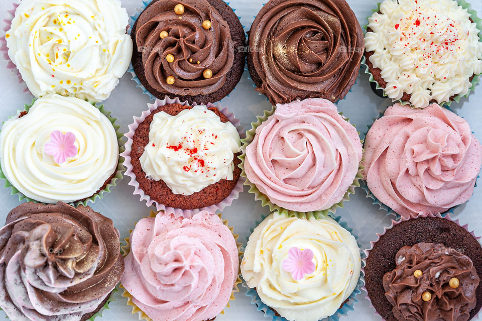 A selection of home baked cupcakes beautifully decorated with buttercream on top.