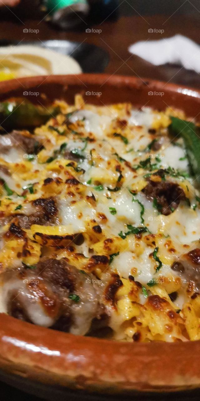 The most delicious dishes in the restaurant are meat with cheese and vegetables