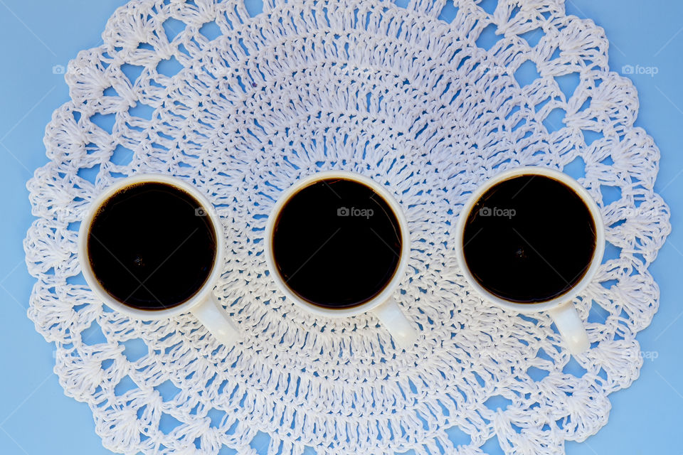 Business working morning with cup of hot coffee, fresh delicious croissant on blue background close up. Top view, copy space, flat lay, mockup.