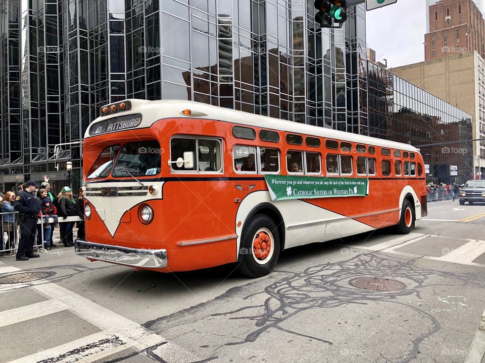 Orange bus in parade