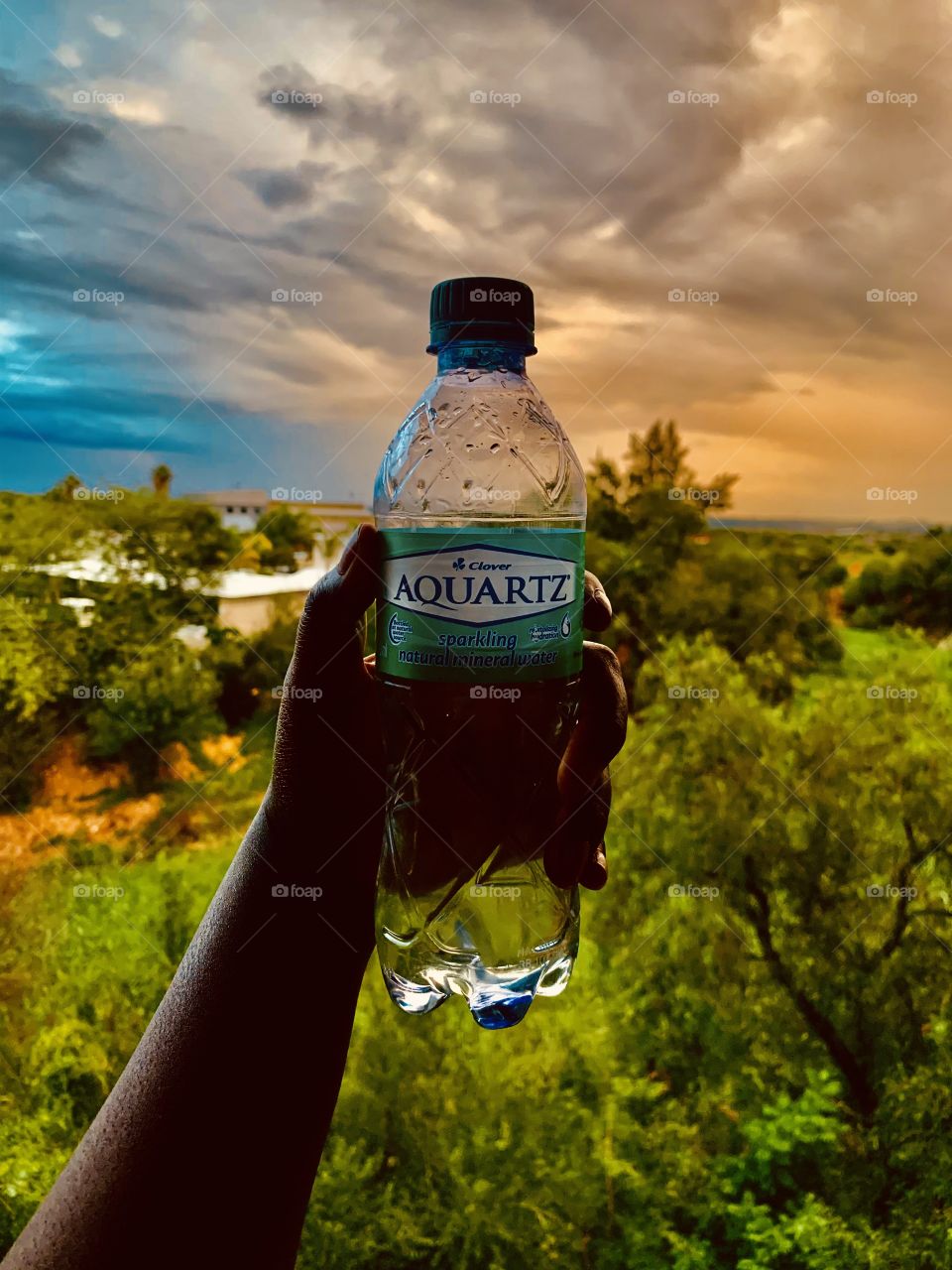 Busy hydrating after a long jog. Jogging is much fun at sunset especially when it is cloudy. Finish it off with a good bottle of water.