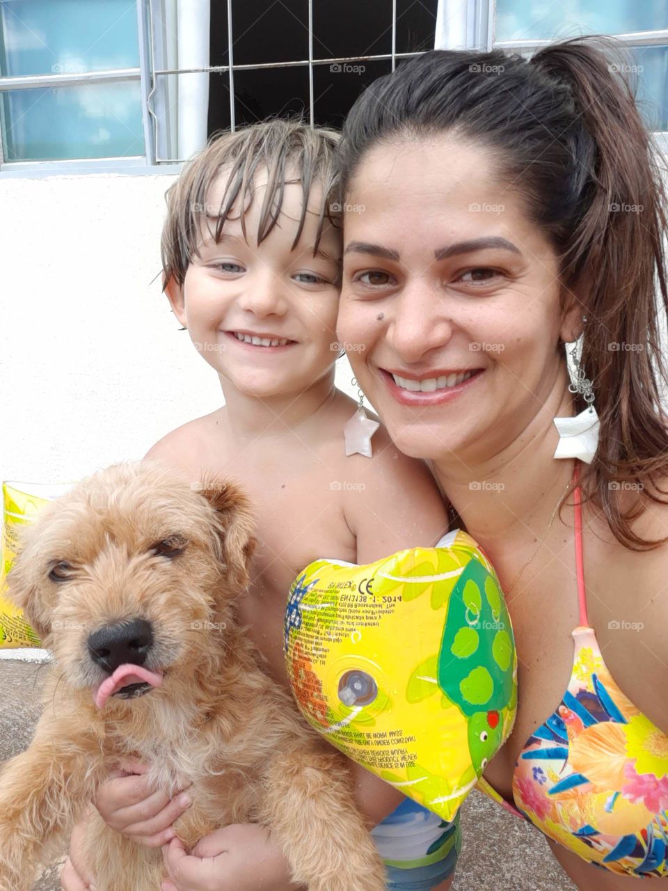 mother and child playing with the dog