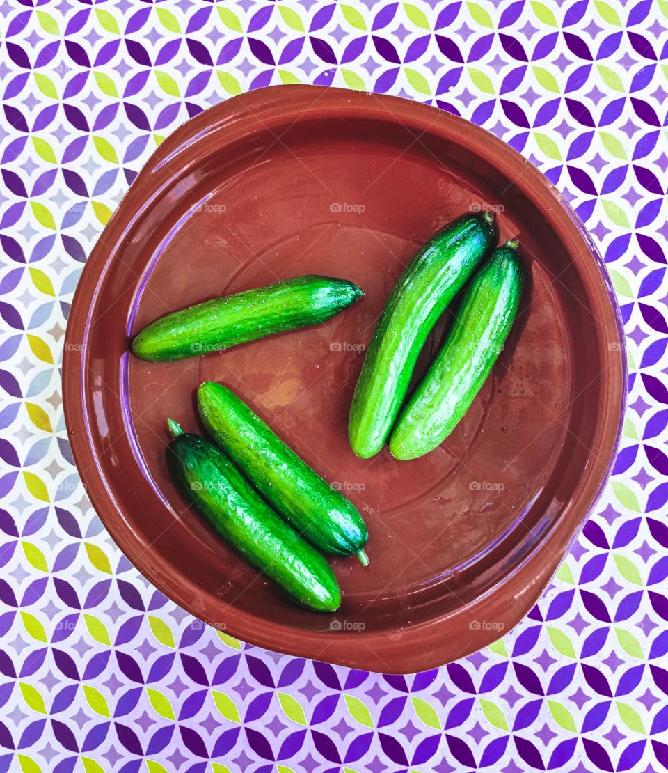 five cucumbers on a plate