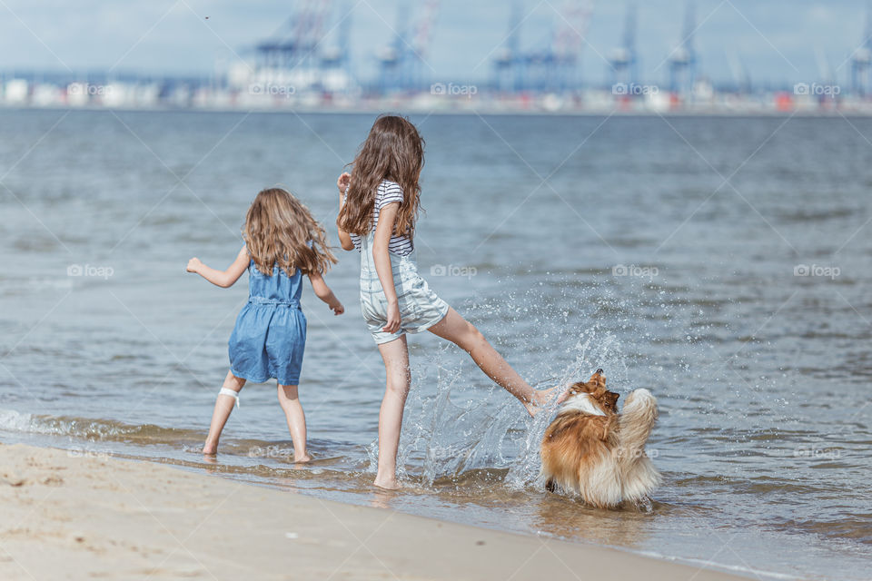 Girls with dog on the beach