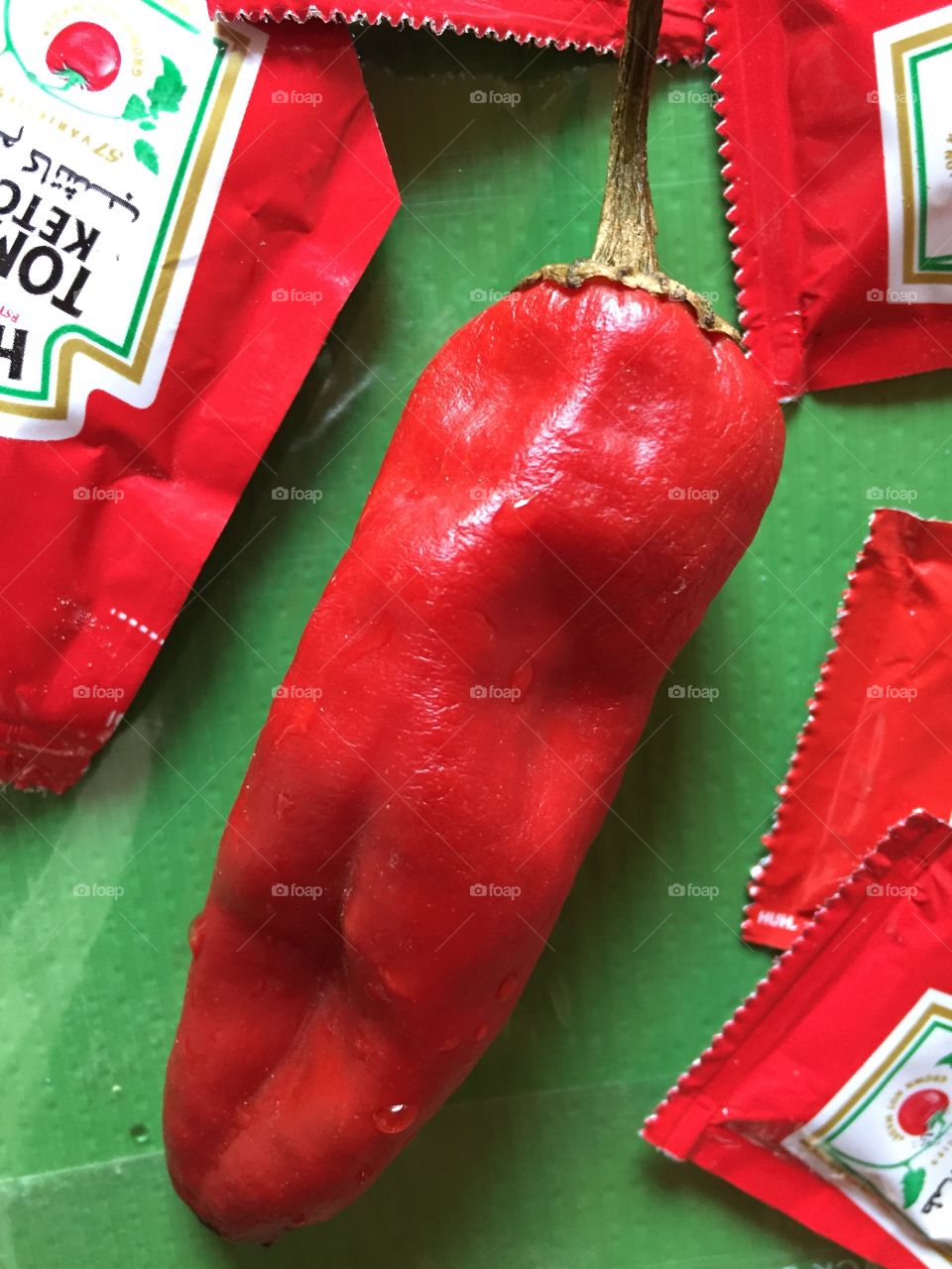 Red pepper on green background 