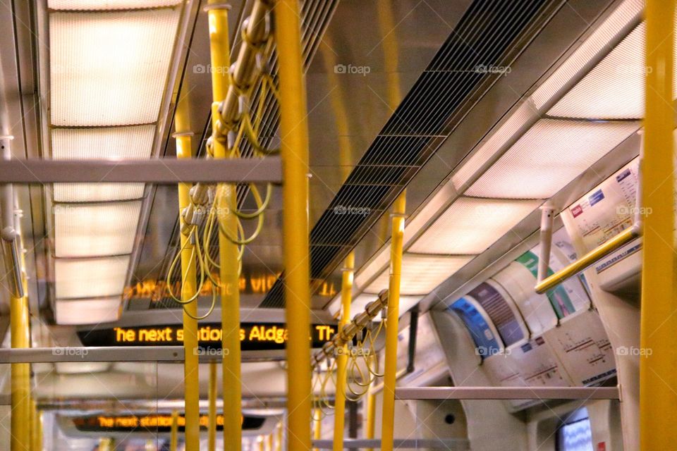 Close-up of yellow hand straps and bars for holding on to on a bus