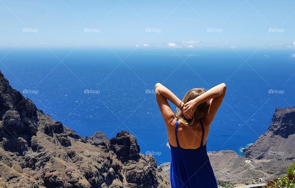 woman looking at the atlantic ocean on la gomera canary island in Spain