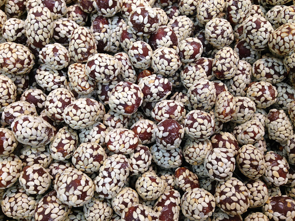 Natural background made of peanuts in sesame seeds 