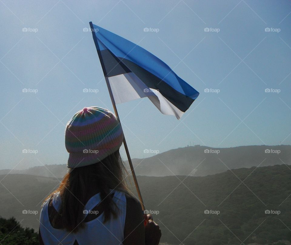 Estonian flag held by woman