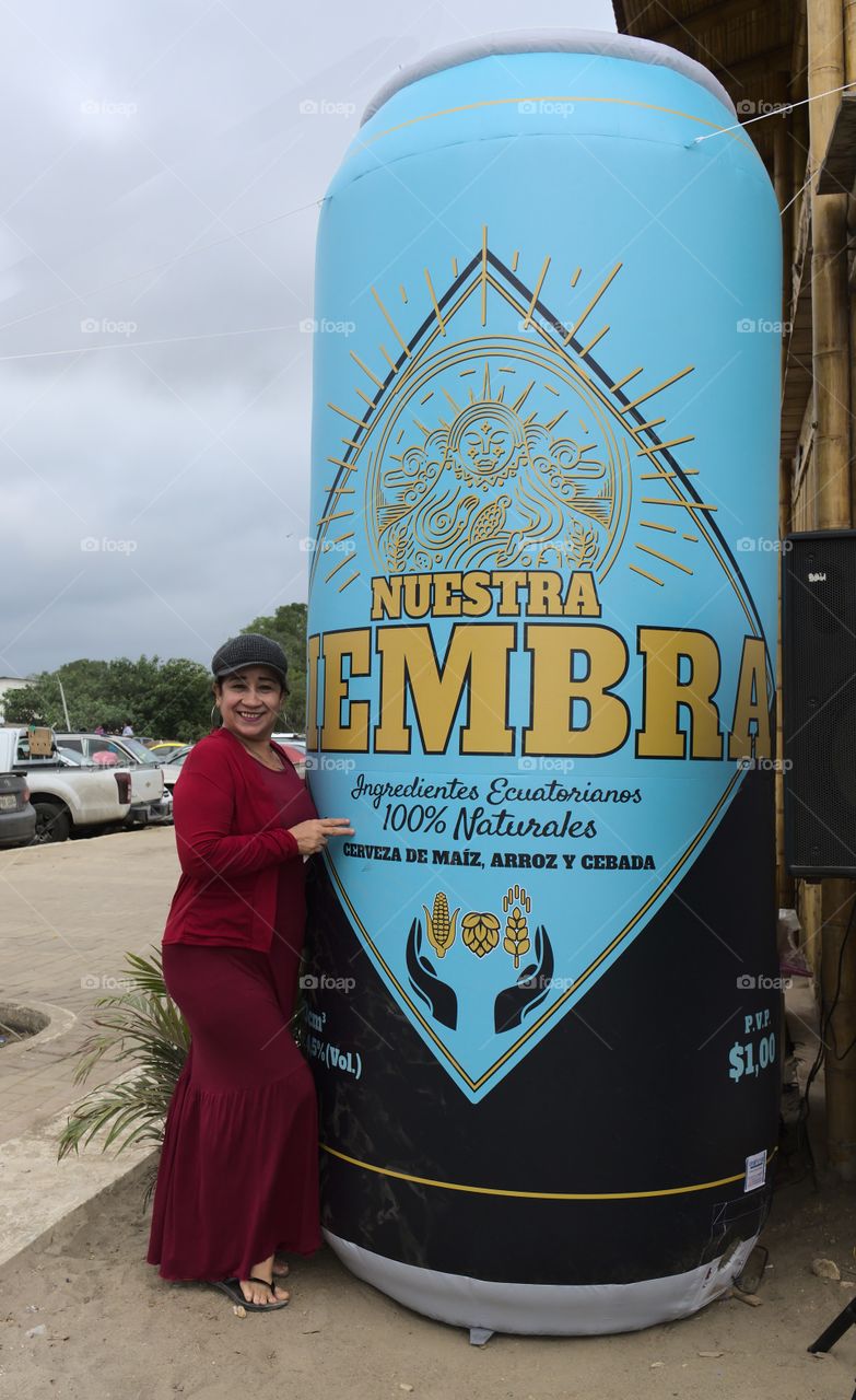 Beautiful woman clutching a giant beer. Woman desires a large beer. Giant beer in a restaurant.