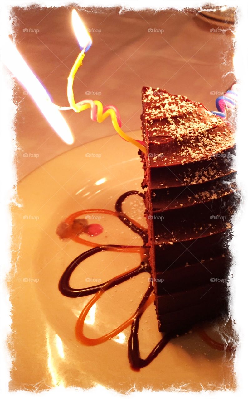 Chocolate Birthday Surprise. Chocolate cake with burning candle