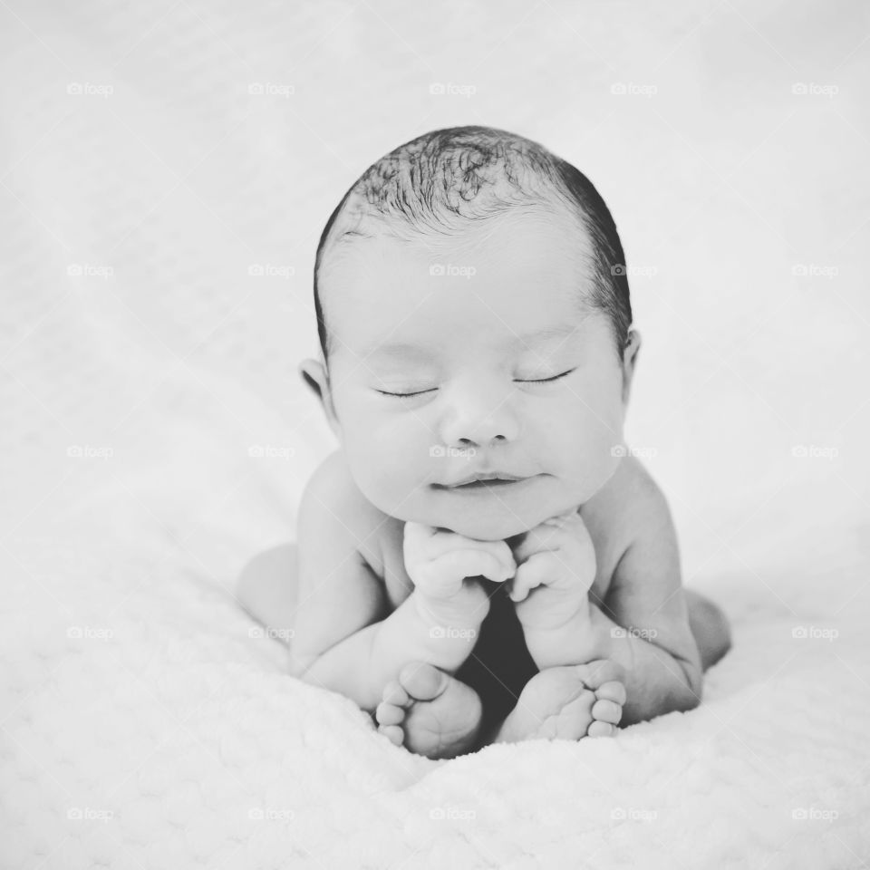 Portrait of newborn baby on bed