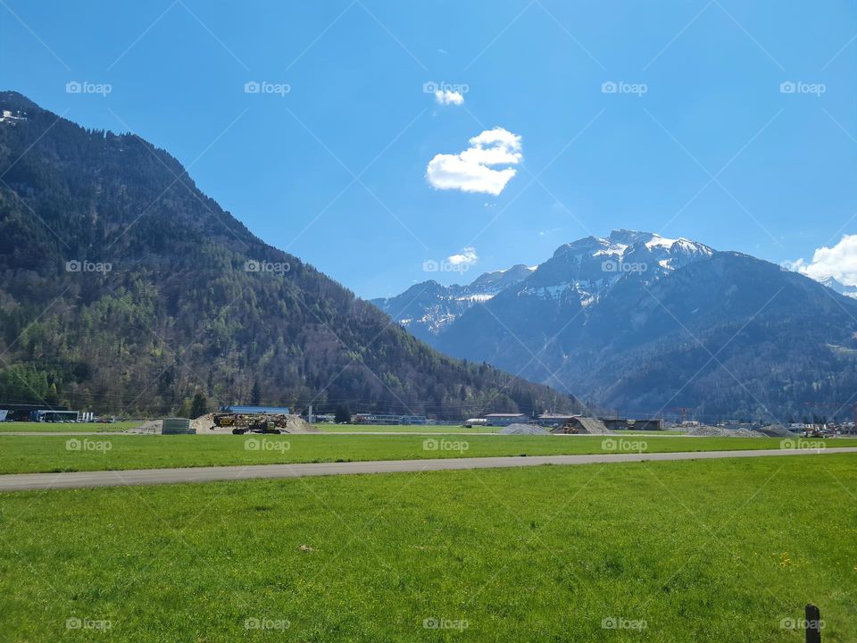 heart shaped clouds above swiss mountains