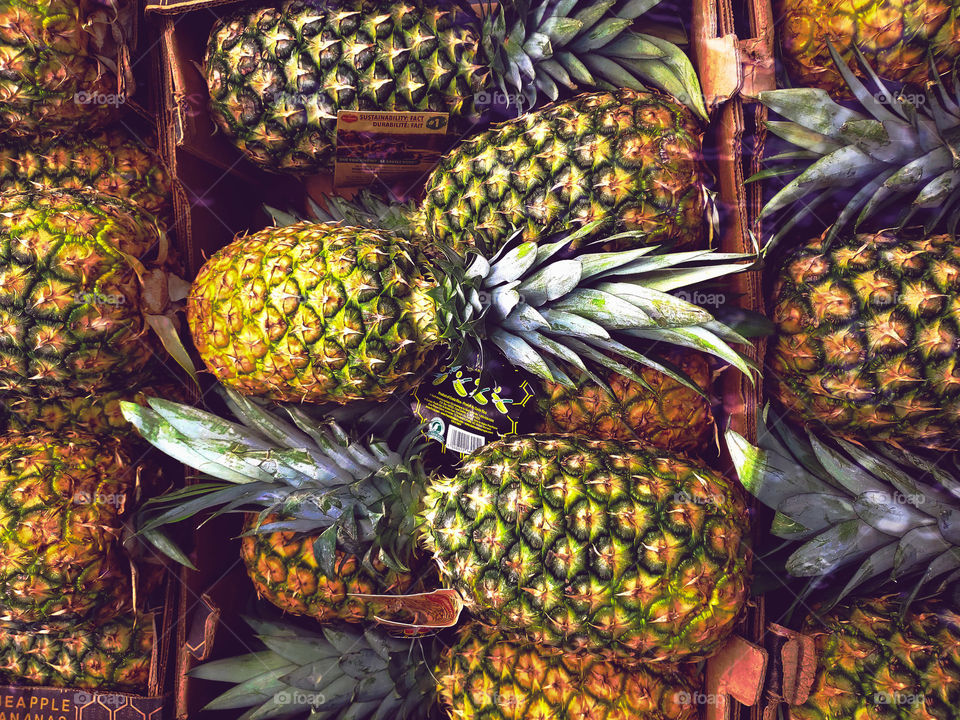 pineapples stacked at the market