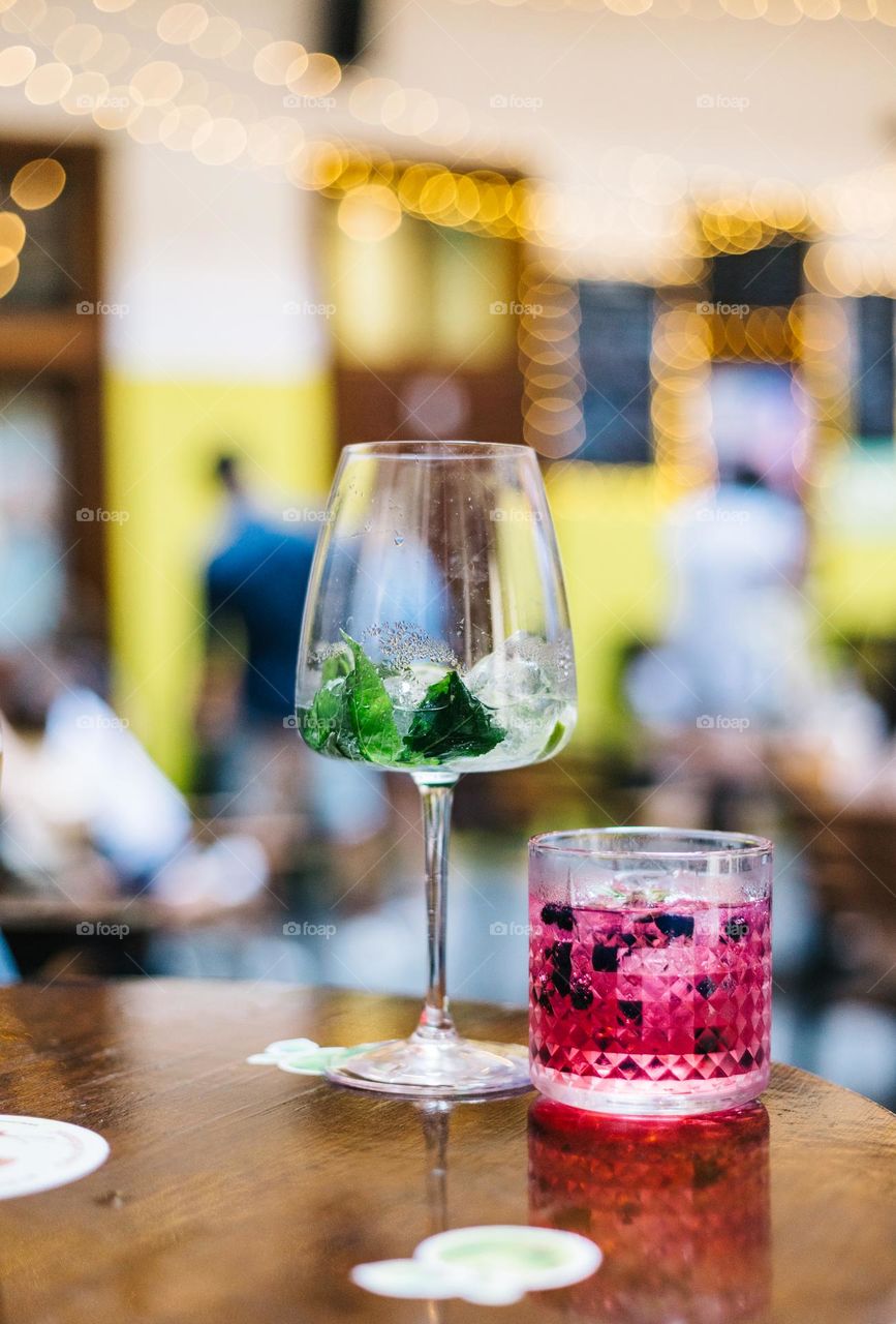 Colorful cocktais drinks served at an event, at a bar in the city, on a summer evening.