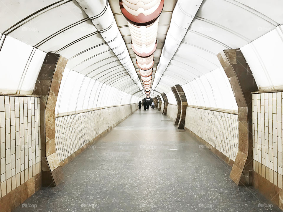 People waiting through the subway tunnel 