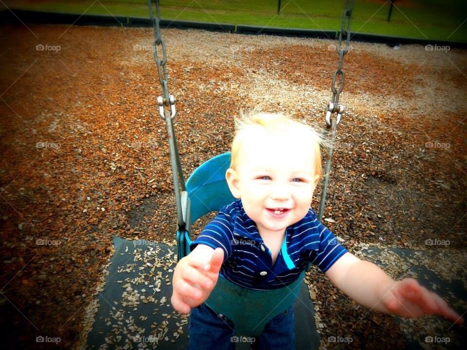 Happy son swinging