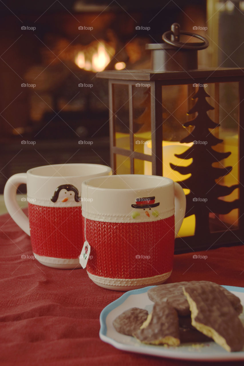 Hygge, cozy up by the fireplace with a hot drink