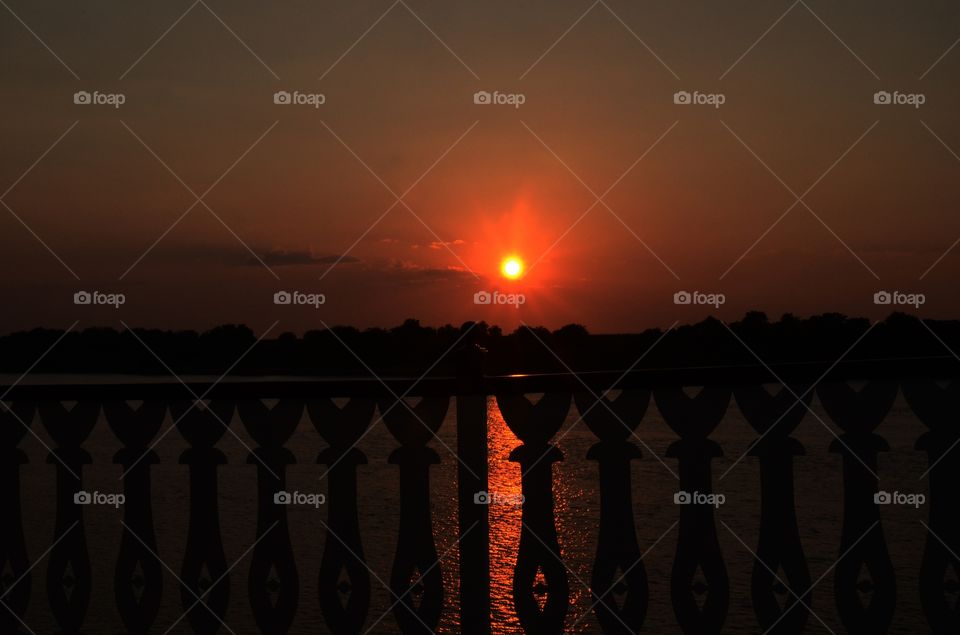 A view from the deck of a river boat cruise down the Savannah river of Georgia offers up a beautiful sunset.