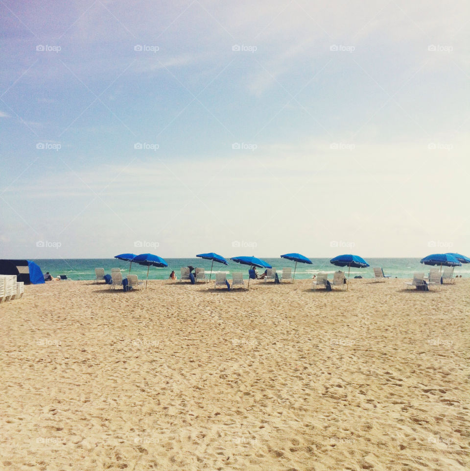 Blue umbrellas on the beach.