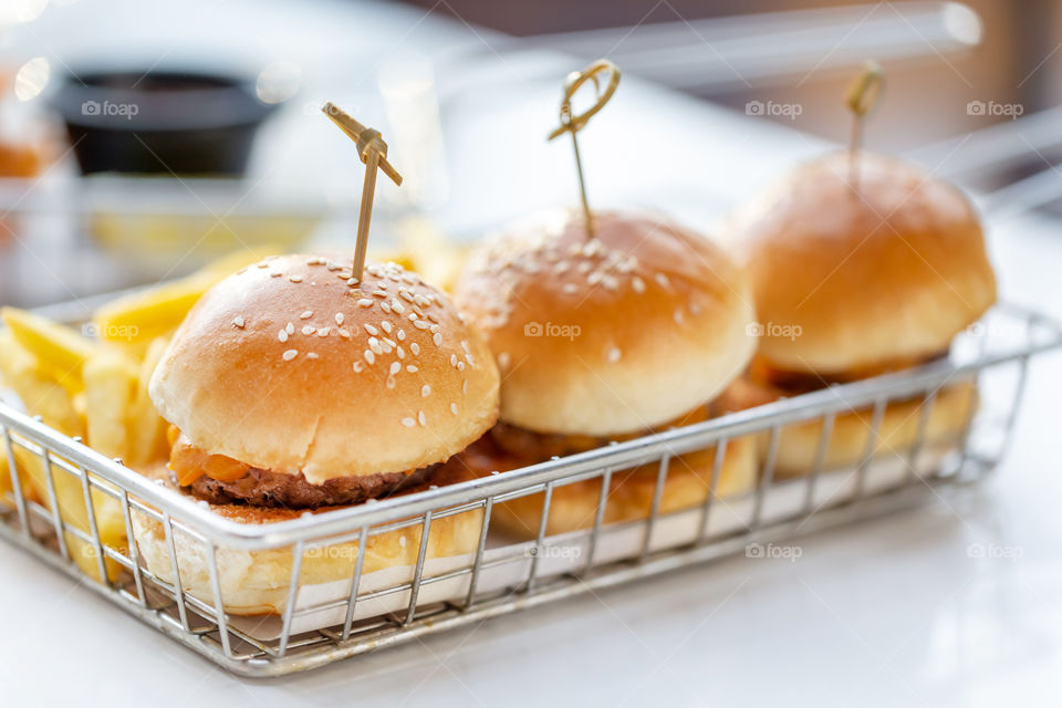 Three juicy delicious mini burders in a tray