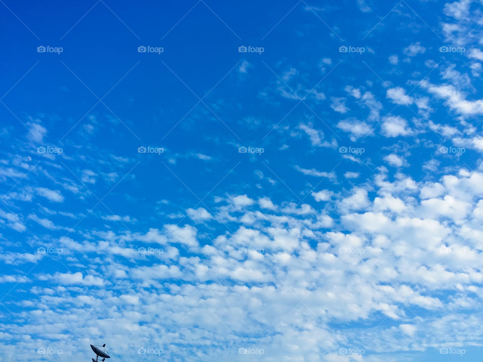 A small satellite dish with a vast beautiful sky.