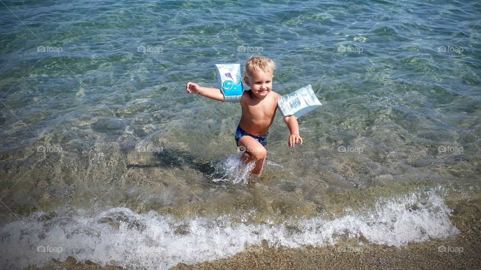 Boy running in water