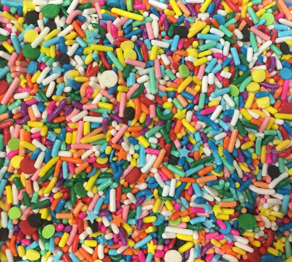 This is a pile of sprinkles. It is multi-colored and a whole bunch of varieties. 