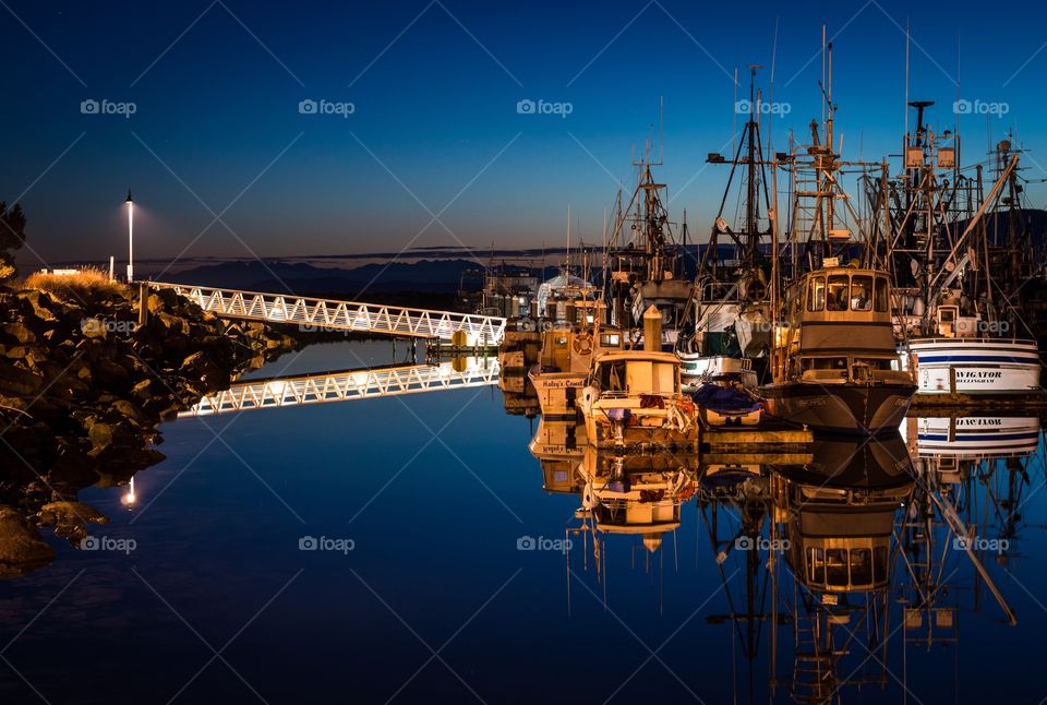 Harbor and boats at blue hour. Fishing boats in the harbor on a calm winter evening during blue hour.