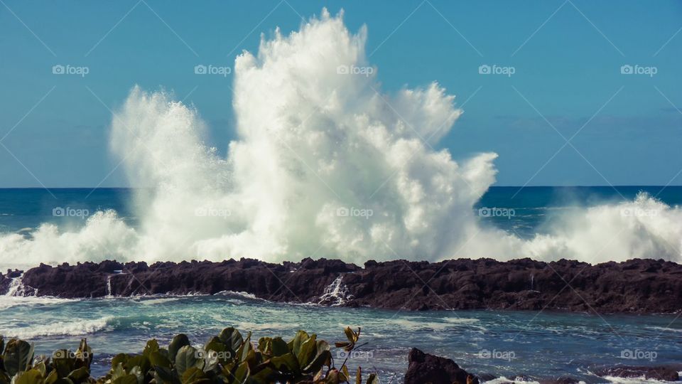Wave crash on rocks big splash 