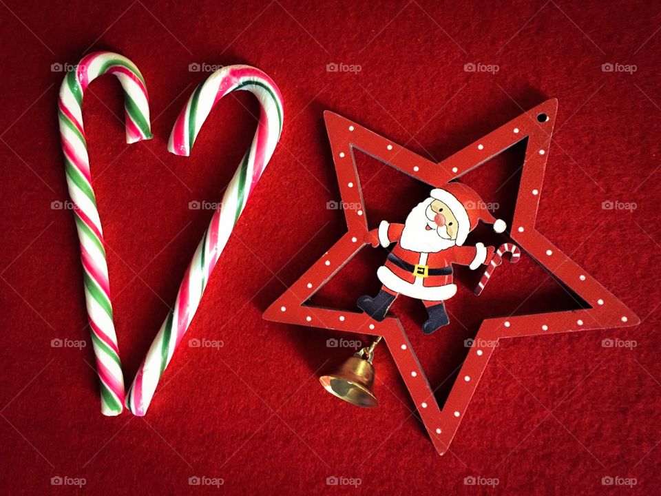 Candy cane and star shape against red background