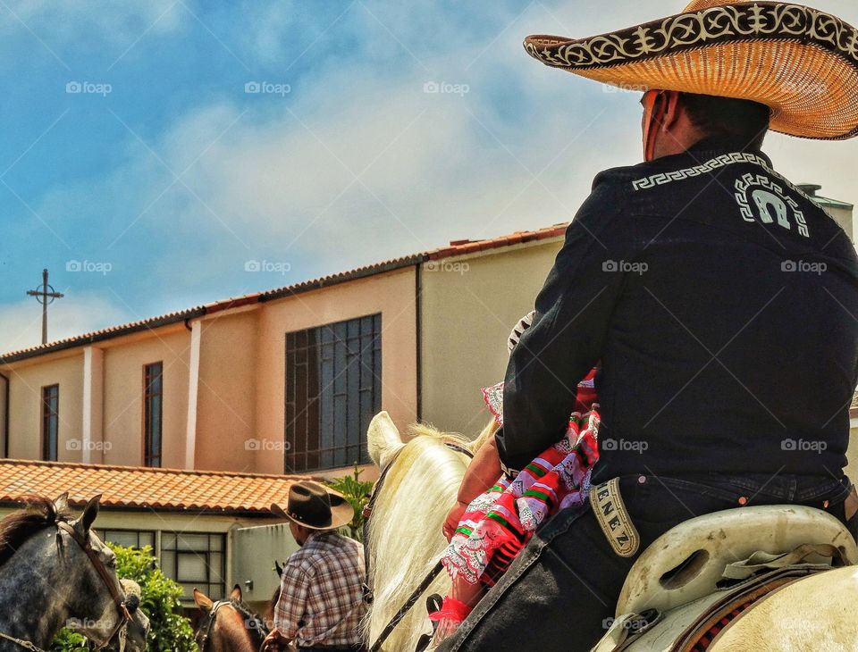 American Cowboy Riding By A Church