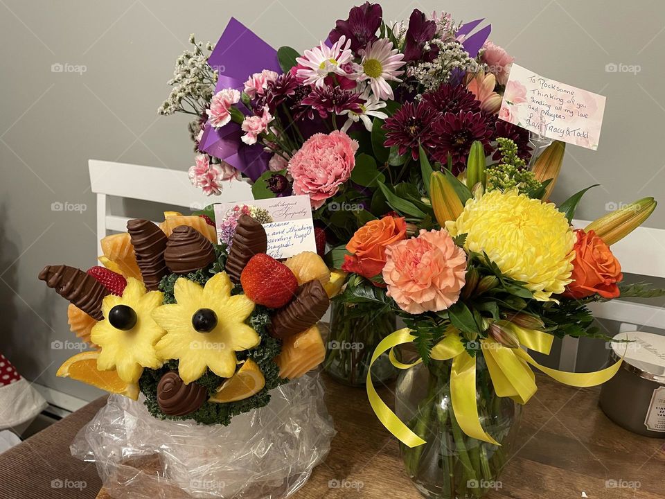Beautiful flowers and fruit bouquets and vases that I received when my youngest son passed away, from an OD, he was only 34, they were so pretty and thoughtful, I had to take this photo with my iPhone 12