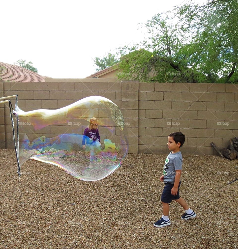 Gigantic bubble and children.