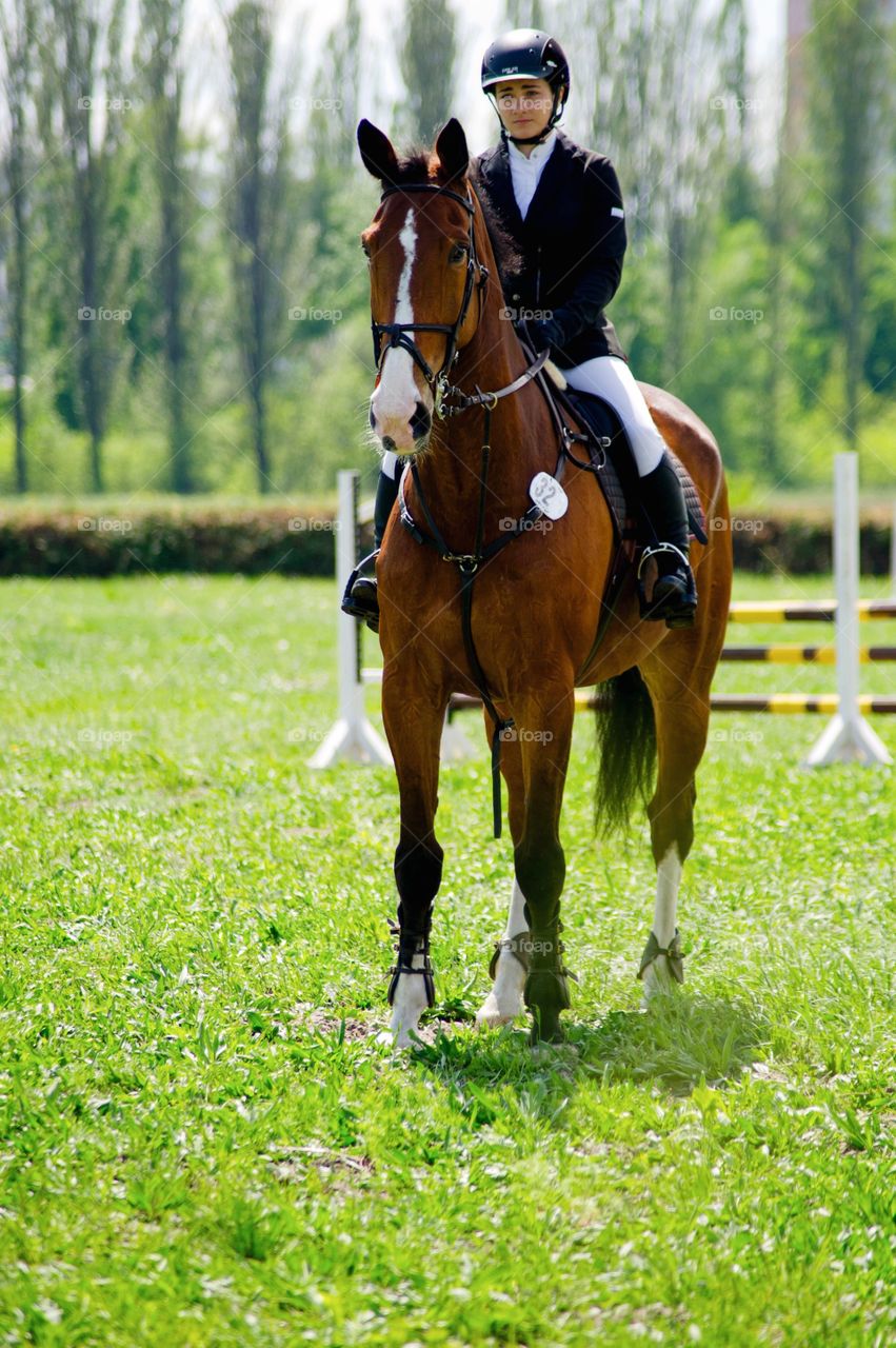 Young woman riding horse